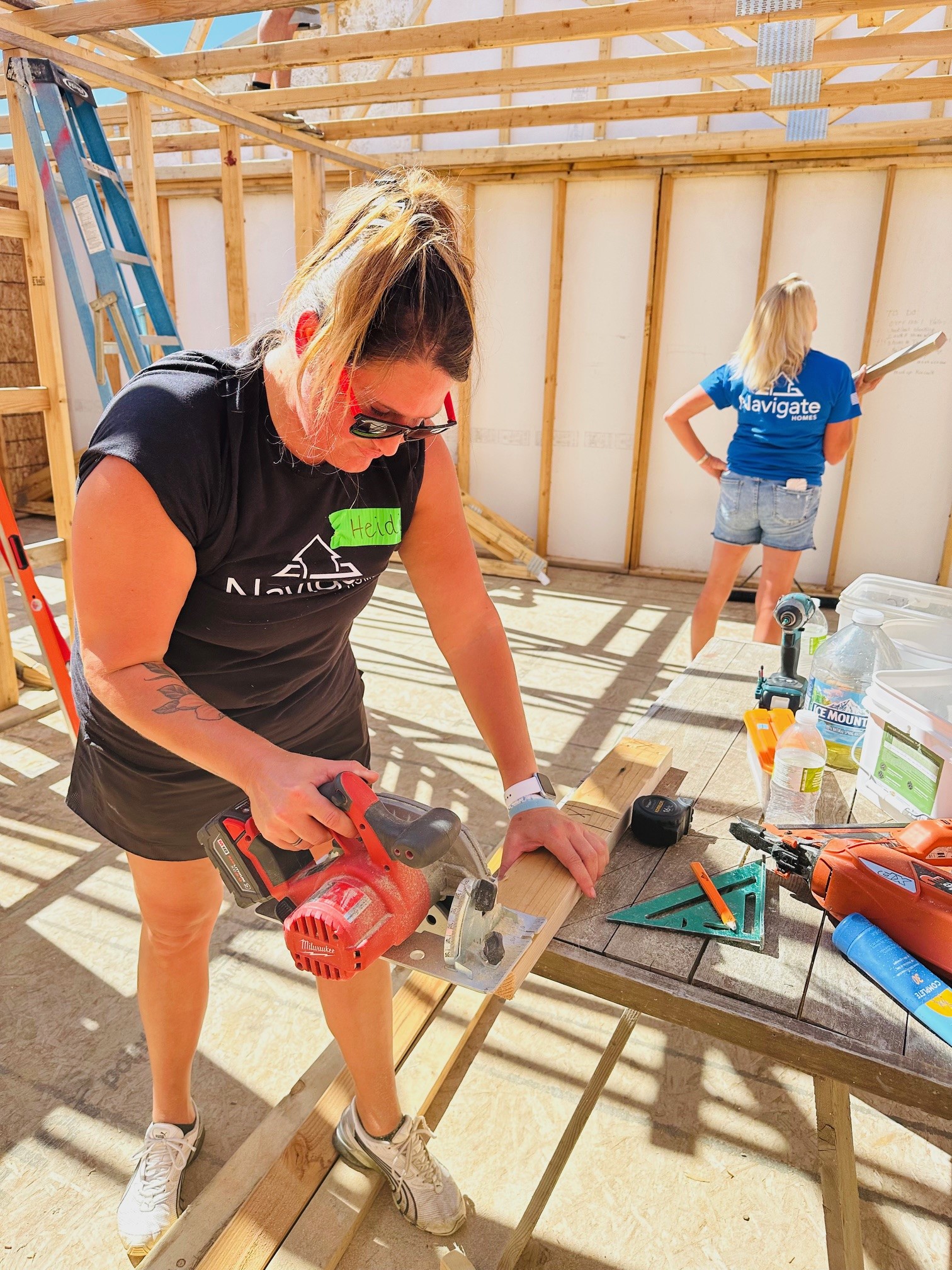 Navigate Homes volunteer cutting lumber during a Habitat for Humanity build
