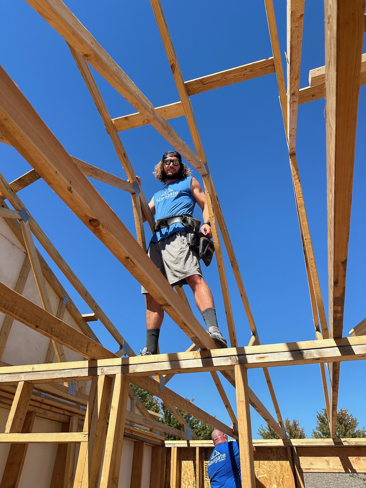 Navigate Homes volunteer working on roof framing