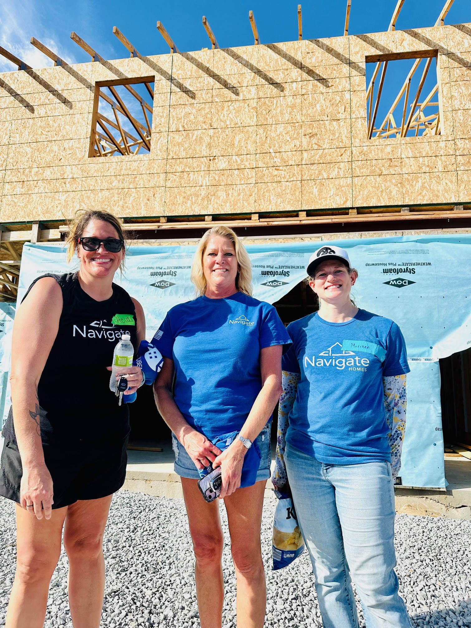 Women from Navigate Homes volunteering at a Habitat for Humanity build